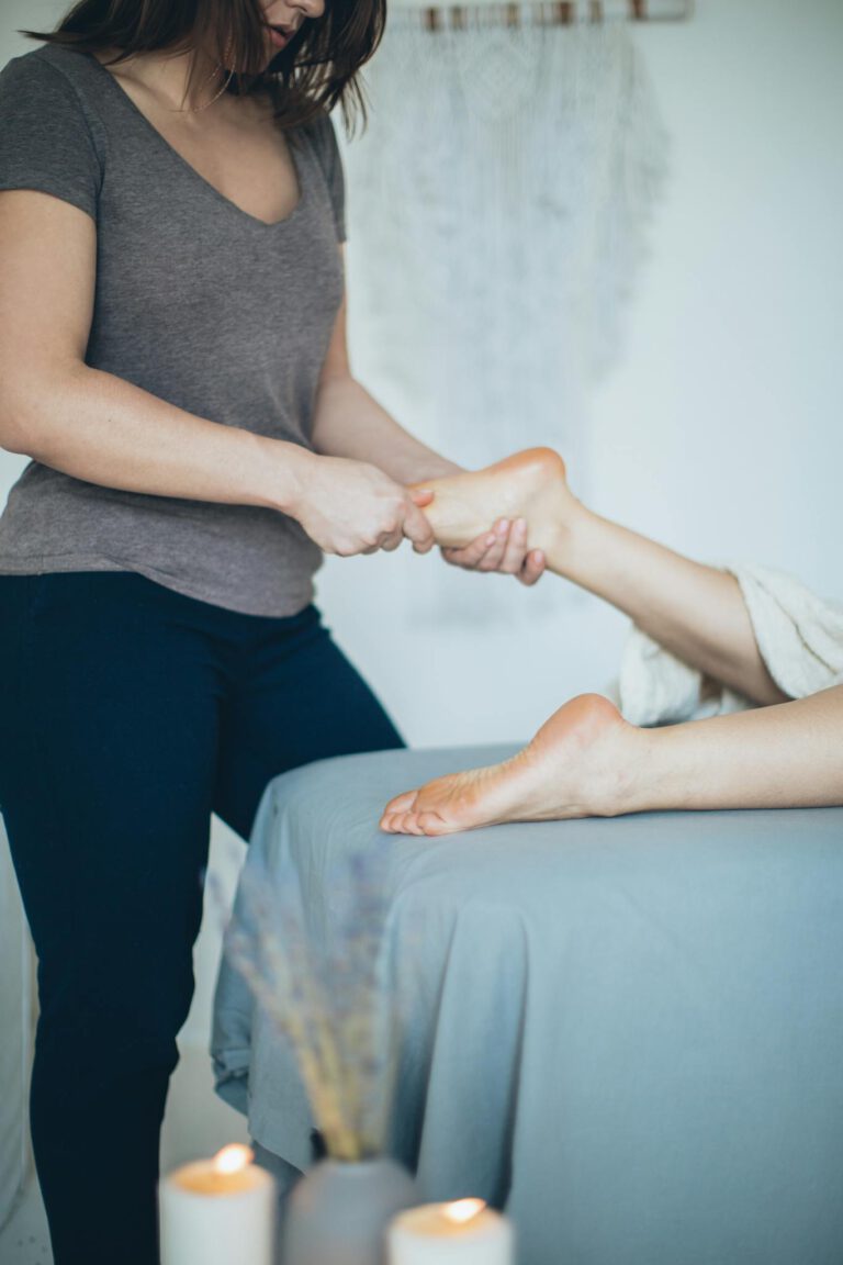 Woman receiving a soothing foot massage at a serene wellness spa for relaxation and therapy.